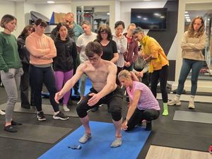 Veronika Cmolikova assessing an attendee's squat during DNS Exercise Part I at Elevate LDN