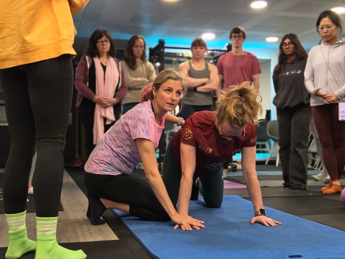 DNS instructor coaching quadruped developmental position with course attendee at Elevate LDN